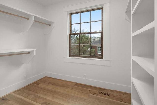 spacious closet featuring light hardwood / wood-style floors