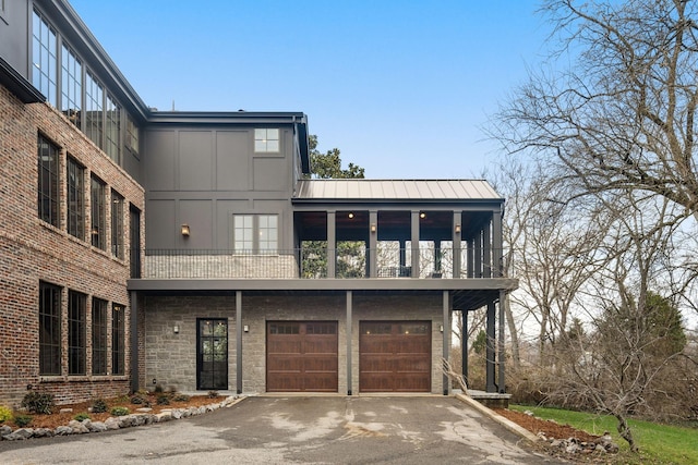 view of front of property with a balcony and a garage