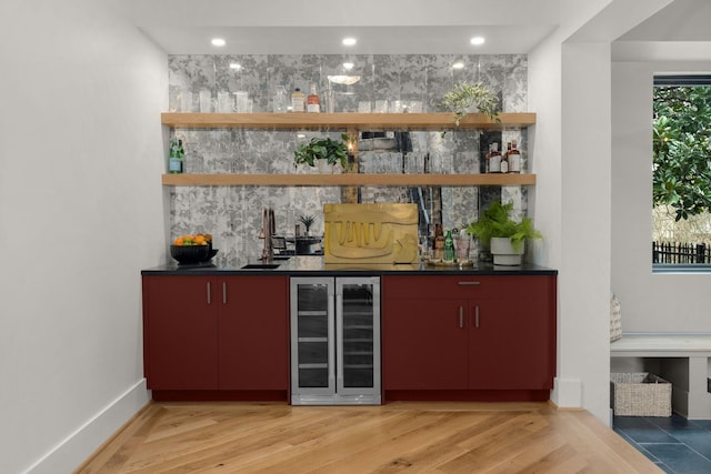 bar featuring wood-type flooring and beverage cooler