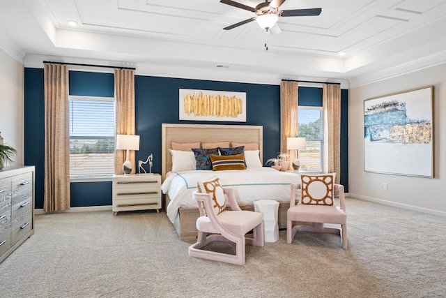 carpeted bedroom featuring ceiling fan, a raised ceiling, and crown molding