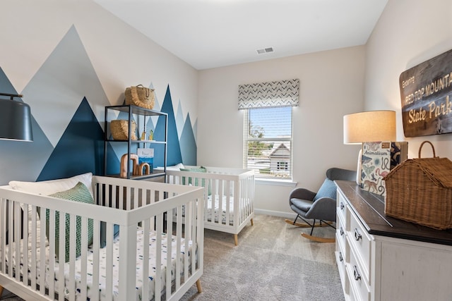 carpeted bedroom featuring a crib