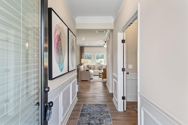 corridor with crown molding and dark hardwood / wood-style flooring