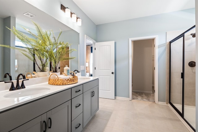 bathroom featuring tile patterned flooring, vanity, and an enclosed shower