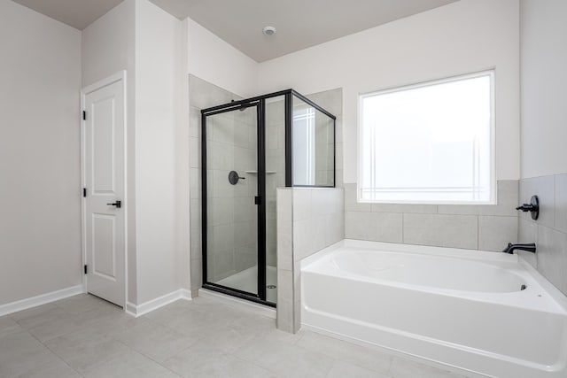 bathroom featuring shower with separate bathtub and tile patterned floors