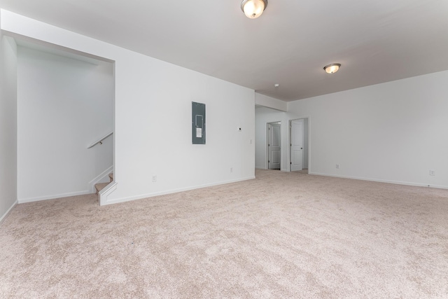 empty room with electric panel and light colored carpet