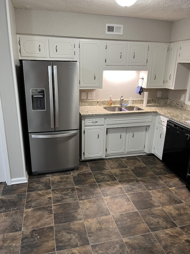 kitchen with dishwasher, stainless steel fridge, white cabinetry, and sink