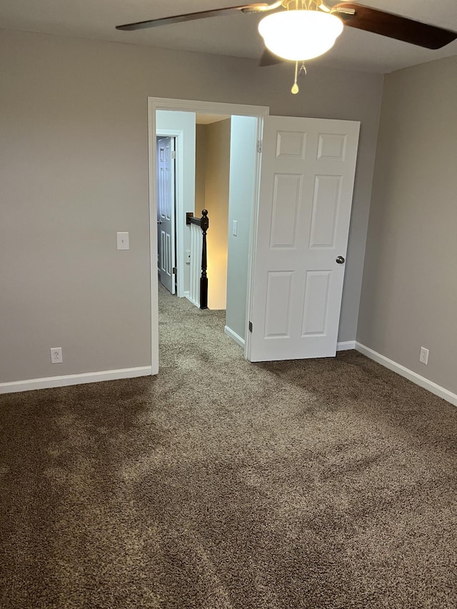 empty room featuring carpet floors and ceiling fan