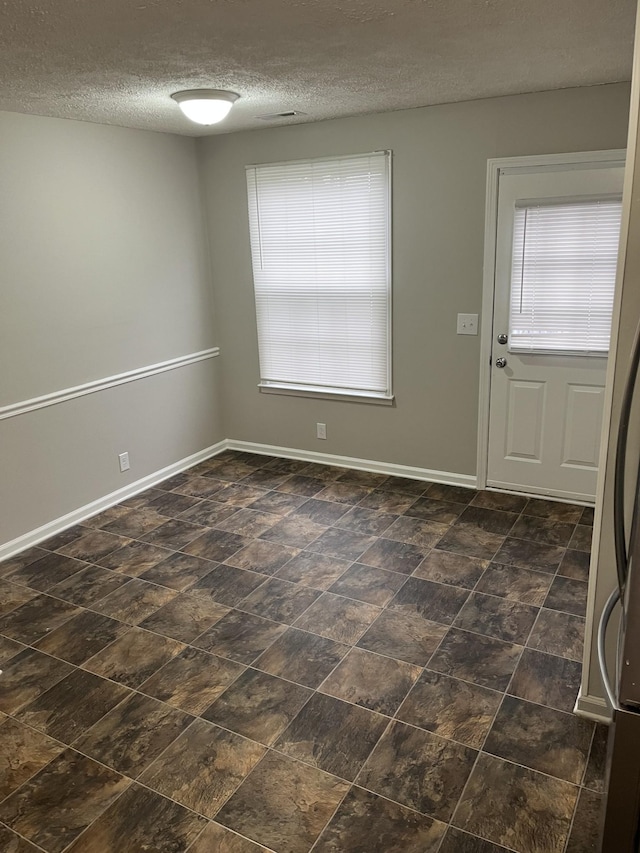 entrance foyer with a textured ceiling