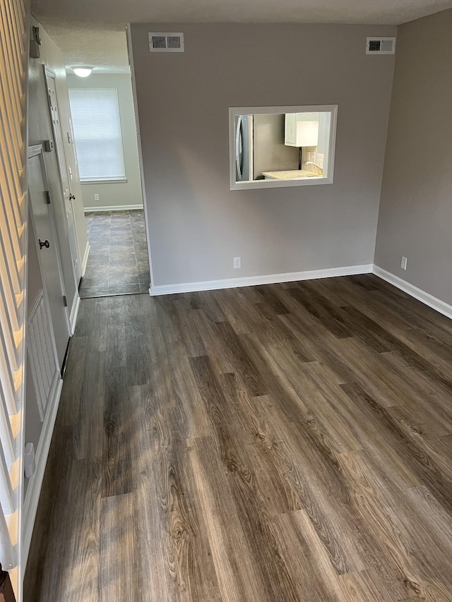 unfurnished room with dark hardwood / wood-style flooring