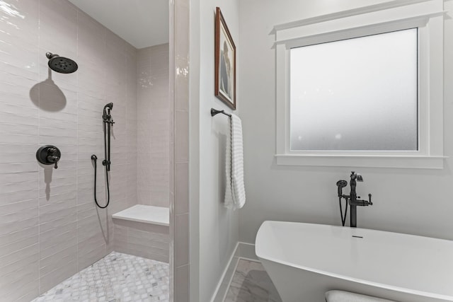 bathroom featuring shower with separate bathtub