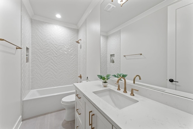 full bathroom with tile patterned floors, toilet, crown molding, tiled shower / bath, and vanity