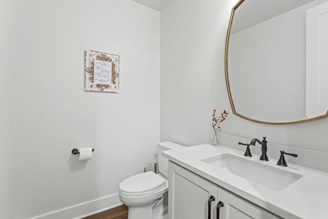 bathroom with vanity, wood-type flooring, and toilet