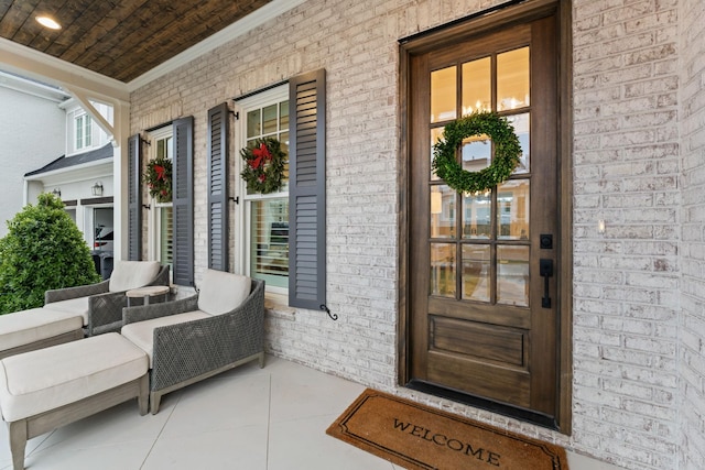 view of exterior entry with covered porch