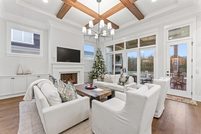 living room with coffered ceiling, dark hardwood / wood-style flooring, a chandelier, and a wealth of natural light