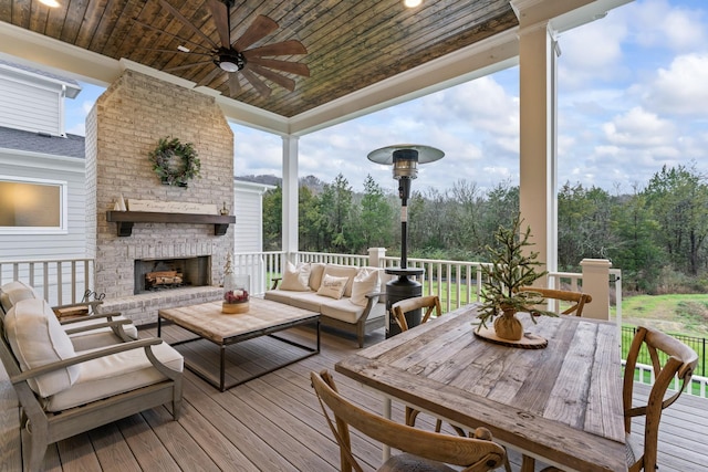 wooden terrace featuring an outdoor living space with a fireplace and ceiling fan