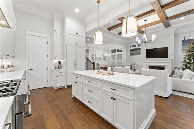 kitchen with a kitchen island, a chandelier, hanging light fixtures, and white cabinets