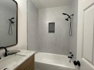 bathroom featuring vanity and tiled shower / bath combo