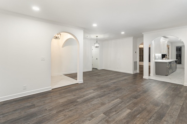 unfurnished living room featuring dark hardwood / wood-style flooring and crown molding