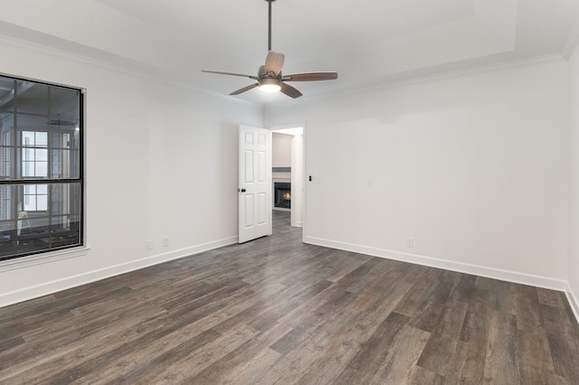 unfurnished room featuring ceiling fan, dark hardwood / wood-style flooring, and ornamental molding