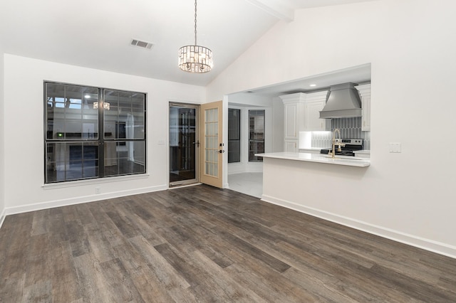 interior space with beam ceiling, dark hardwood / wood-style floors, an inviting chandelier, and sink