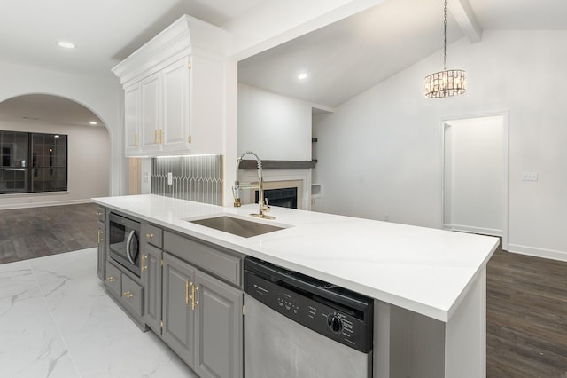 kitchen featuring white cabinets, sink, vaulted ceiling with beams, gray cabinets, and stainless steel appliances