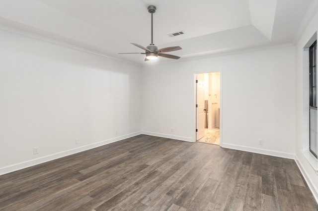 empty room featuring dark hardwood / wood-style flooring, ceiling fan, and crown molding