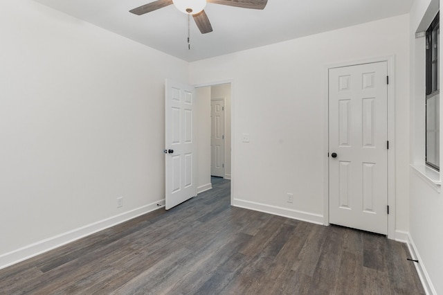 unfurnished bedroom with ceiling fan and dark hardwood / wood-style flooring