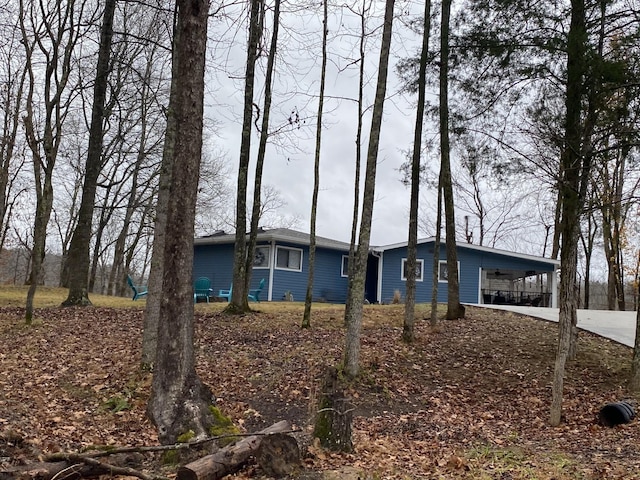 view of side of property with a carport