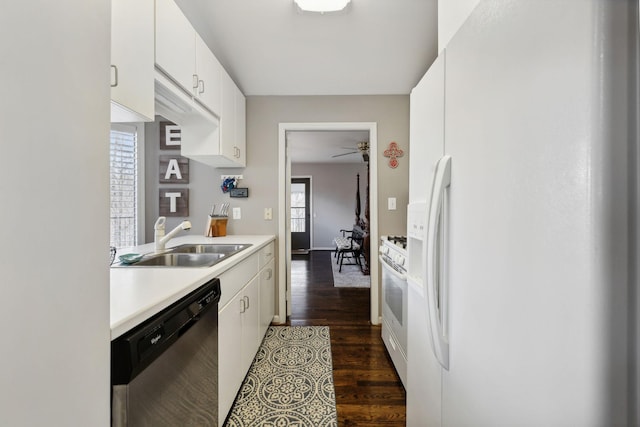 kitchen featuring white appliances, white cabinets, sink, dark hardwood / wood-style floors, and ceiling fan