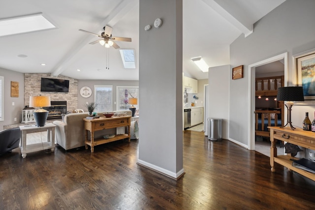 living room with a fireplace, ceiling fan, high vaulted ceiling, beamed ceiling, and dark hardwood / wood-style floors