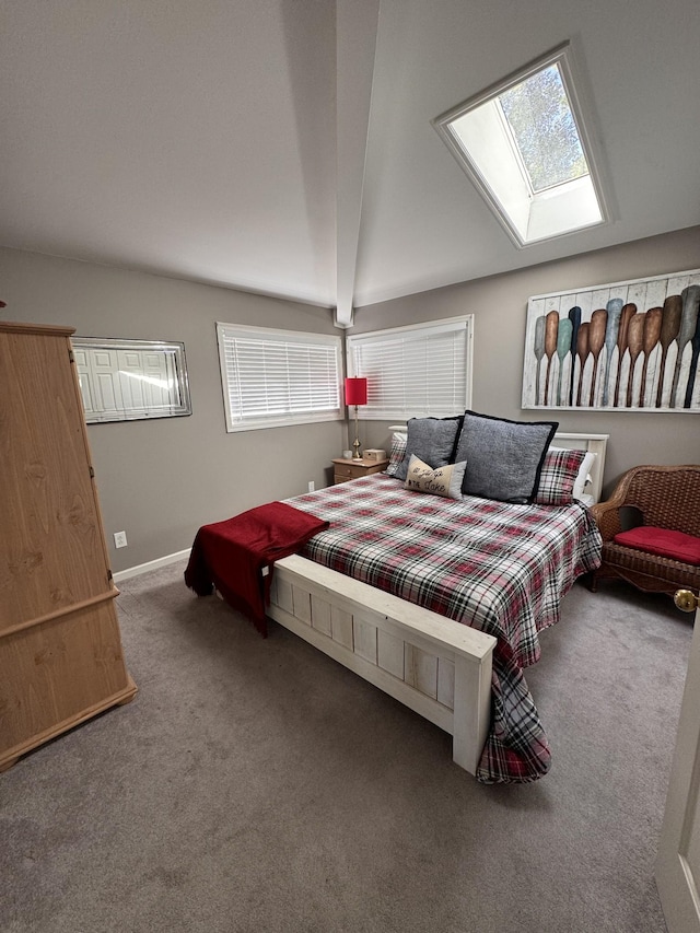 bedroom featuring beam ceiling, a skylight, and carpet floors