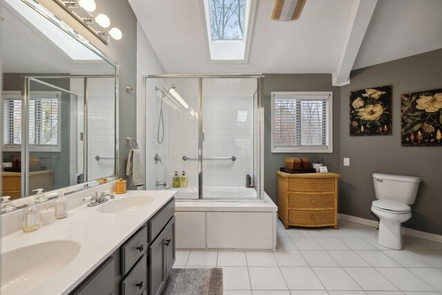 full bathroom featuring shower / bath combination with glass door, a skylight, a wealth of natural light, and tile patterned flooring