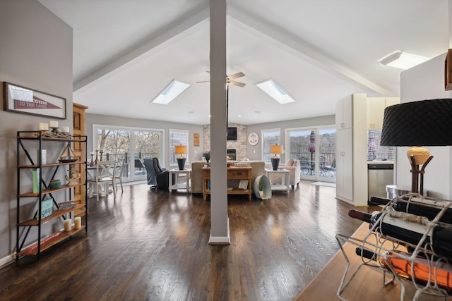 living room featuring plenty of natural light, ceiling fan, dark hardwood / wood-style flooring, and lofted ceiling with beams