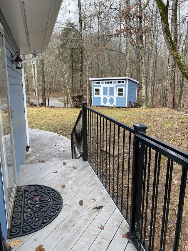 deck featuring a storage shed and a lawn