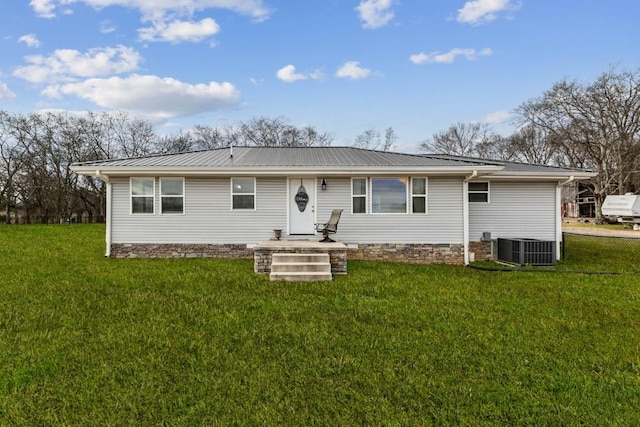 rear view of house with a lawn and central air condition unit