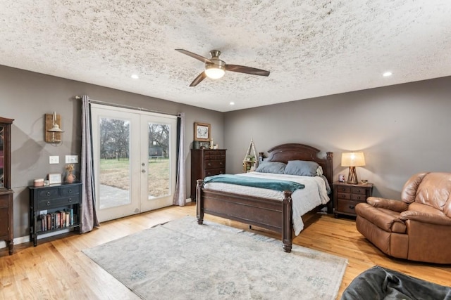 bedroom with french doors, light wood-type flooring, a textured ceiling, access to outside, and ceiling fan