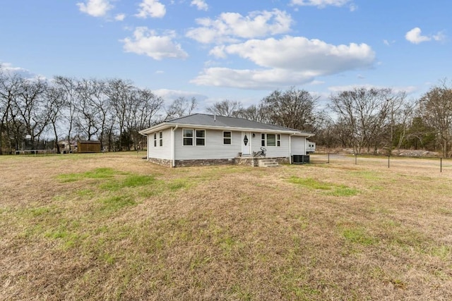 rear view of house featuring a yard and central AC unit