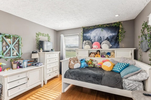 bedroom featuring a textured ceiling and light wood-type flooring