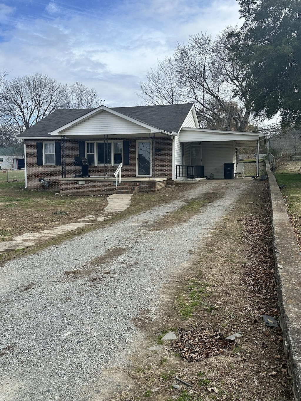 view of front of home with covered porch and a carport