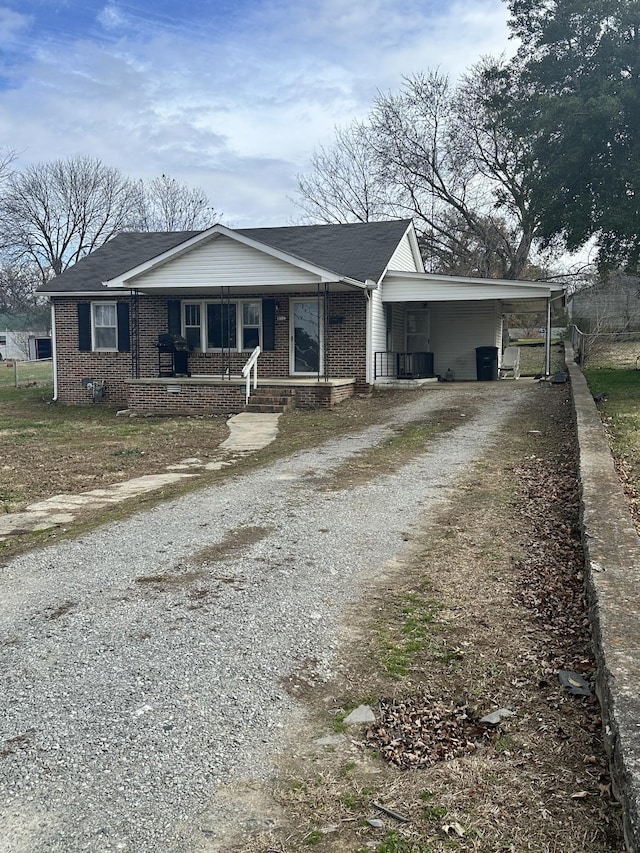 view of front of home with covered porch and a carport