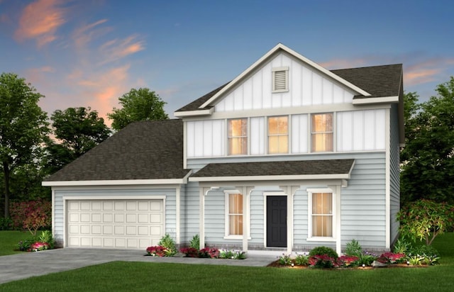 view of front of home featuring a yard and a garage