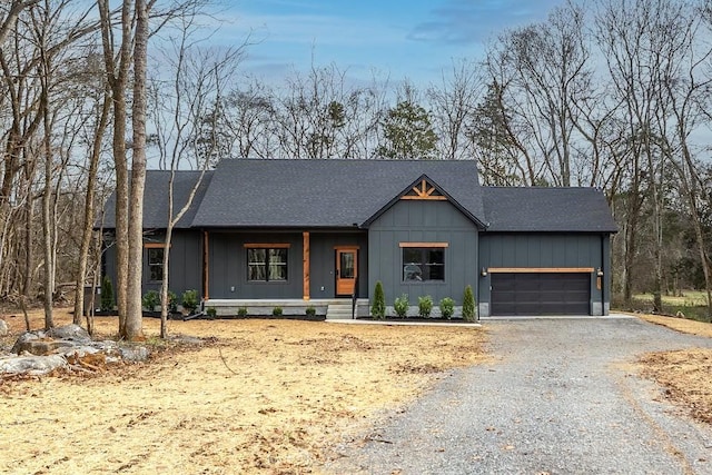 modern farmhouse featuring covered porch and a garage