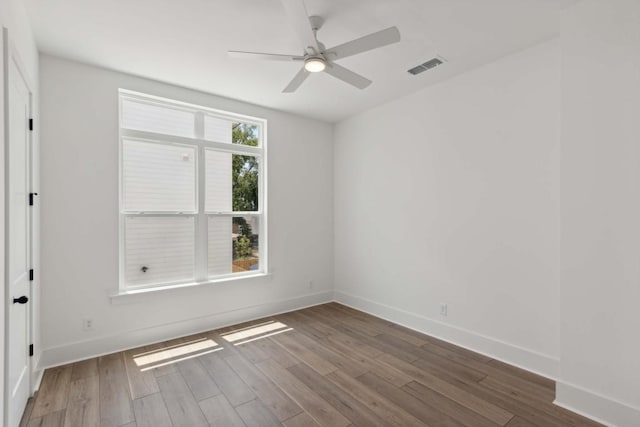 empty room featuring ceiling fan and hardwood / wood-style floors