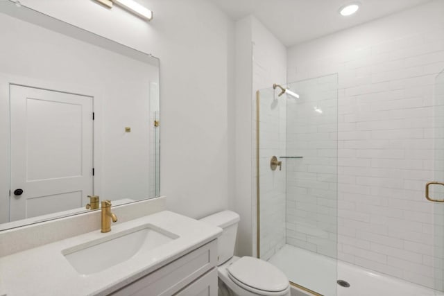 bathroom with vanity, toilet, and an enclosed shower