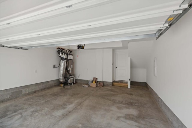 garage with a garage door opener and water heater