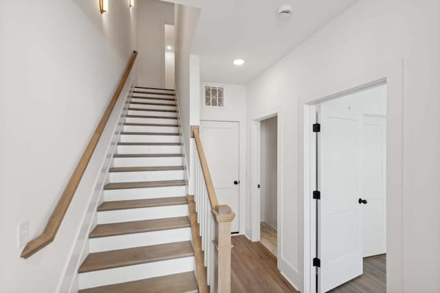 stairs featuring hardwood / wood-style flooring