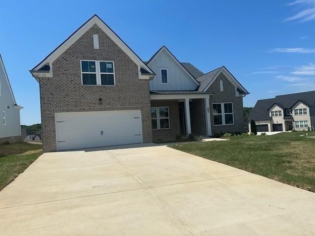 view of front of home with a front yard and a garage