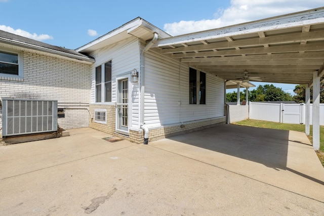 view of property exterior featuring a carport and central AC unit