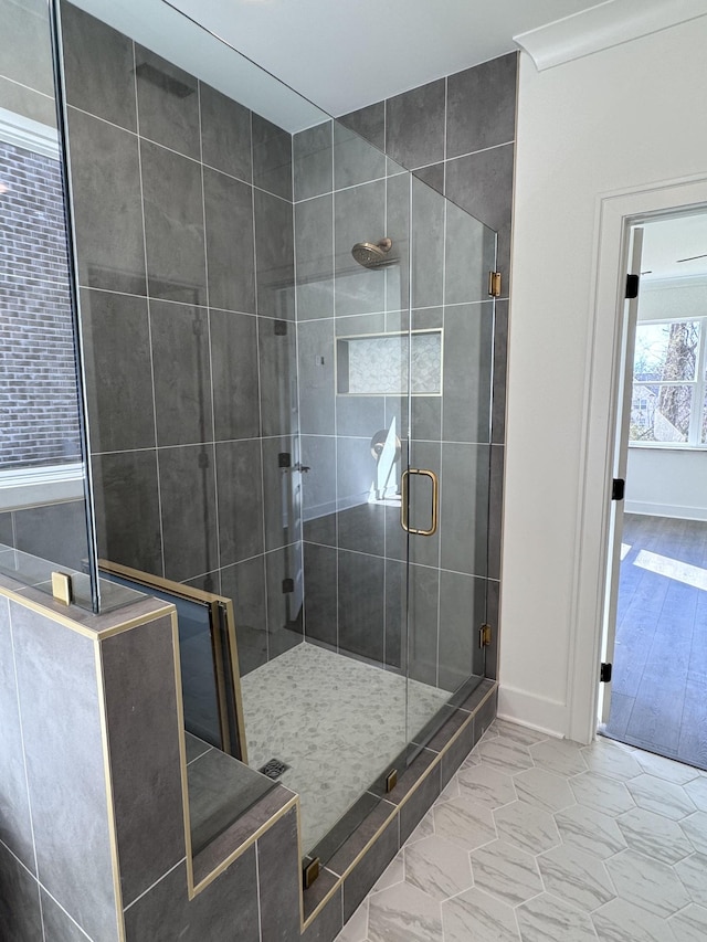 full bathroom featuring baseboards, a stall shower, and marble finish floor