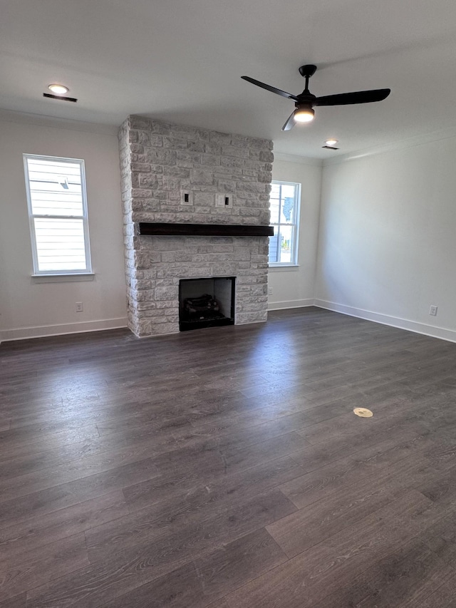 unfurnished living room featuring dark wood-style floors, a fireplace, and baseboards